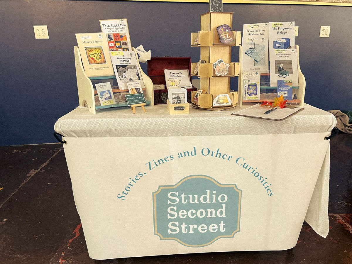 Studio Second Street display table at Johnson City Zine Fest showing handmade zines and chapbooks