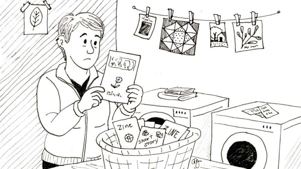 A black-and-white illustration of a woman standing in a laundry room, holding up a zine with a thoughtful expression as if examining a shirt. A laundry basket in front of her is filled with zines, short stories, and creative papers. Behind her, more artwork and small illustrations hang from a clothesline above a washing machine and dryer.