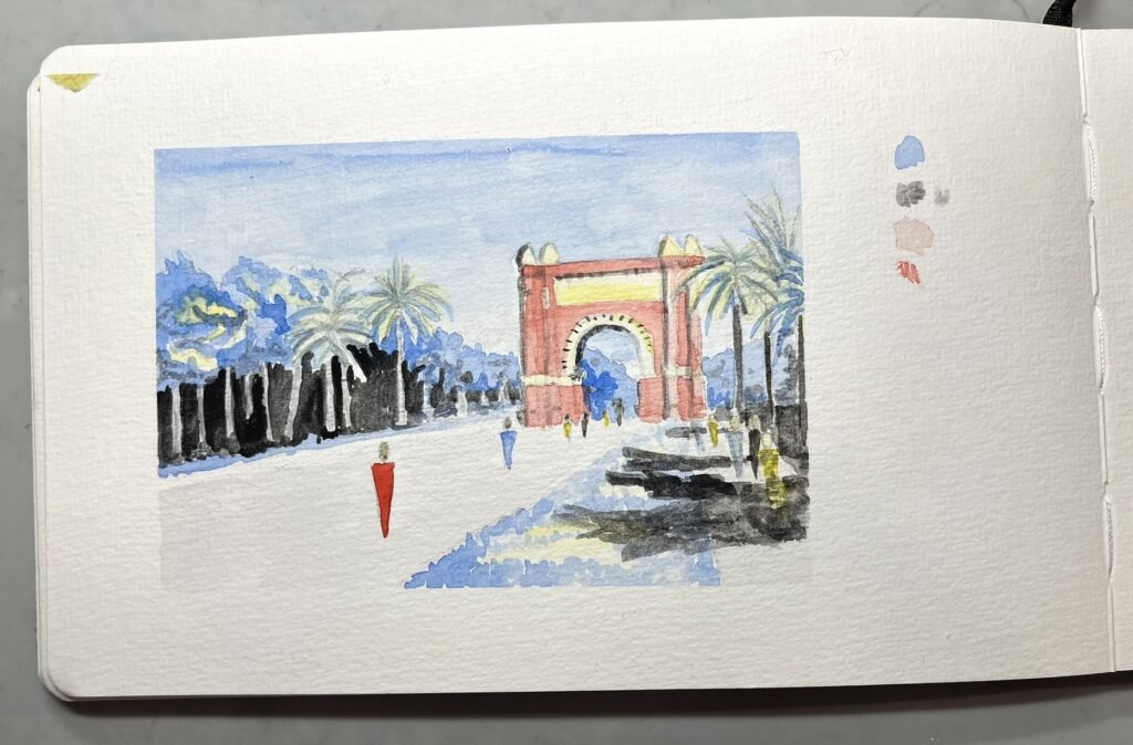 Initial watercolor study of Barcelona’s Arc de Triomf painted with diluted blue, red, yellow, and black before pen details were added.