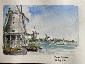 Mixed media sketchbook painting of windmills along the water at Zaanse Schans, with pen linework, watercolor washes, and handwritten date notes.