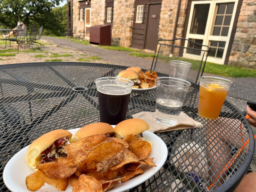 a black patio table with food and beer