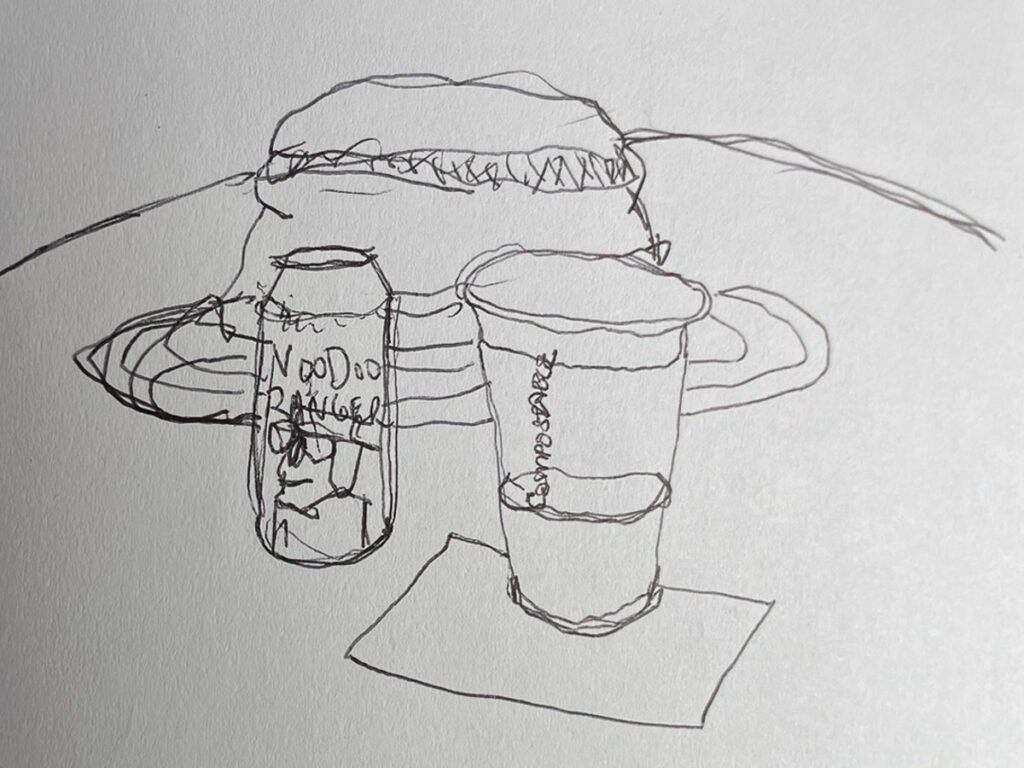 Quick continuous-line sketch of a drink cup, a beverage can, and a wide-brimmed hat on an outdoor table.