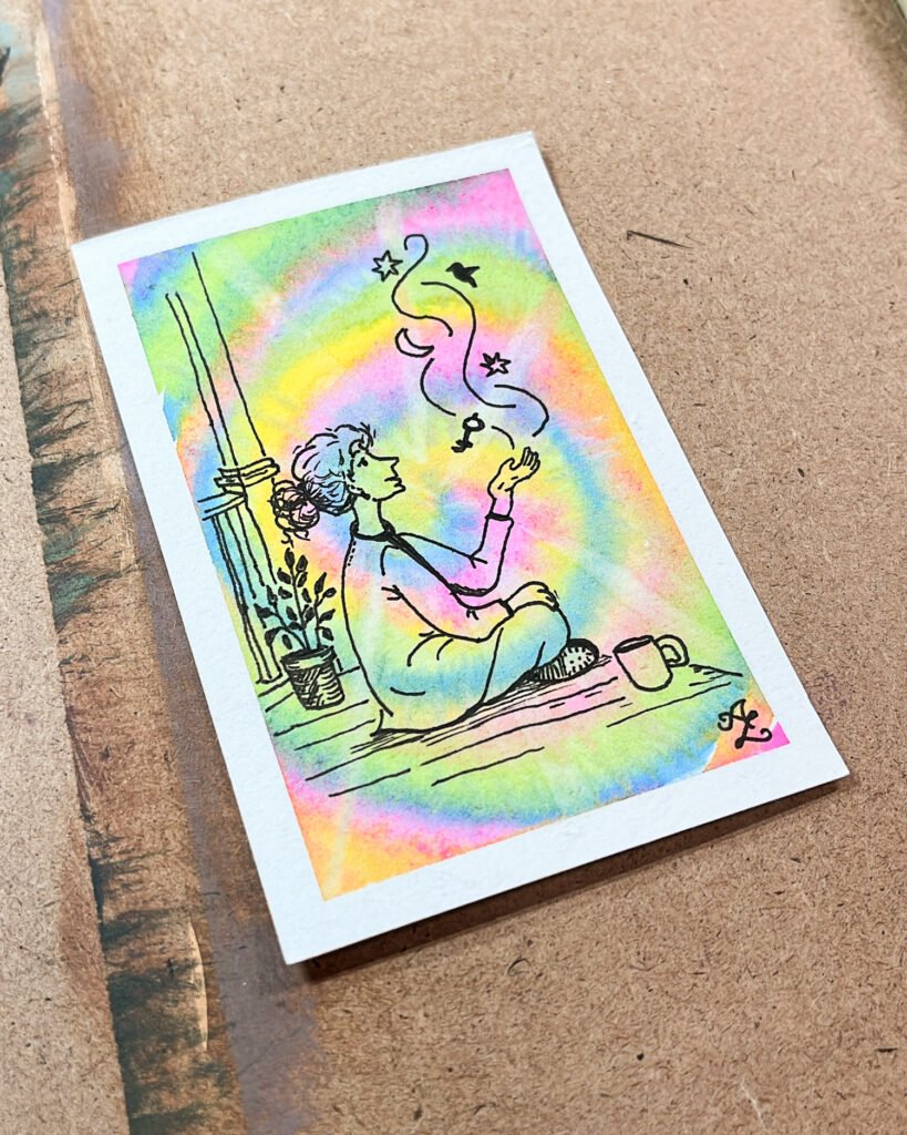 A rainbow watercolor ACEO showing a seated woman releasing a moon, stars, bird, and key from her raised hand.